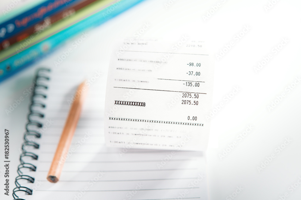 Grocery shopping list on notebook and pencil - money account management concept Grocery shopping list on notebook and pencil - money account management concept
