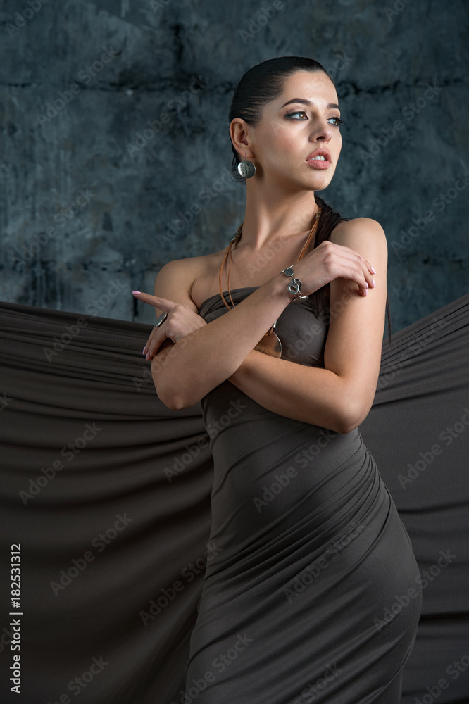 expensive jewelry wreath earrings and ring on a beautiful sexy nude elegant brunette girl with bared shoulders with bright evening make-up expensive jewelry wreath earrings and ring on a beautiful sexy nude elegant brunette girl with bared shoulders with bright evening make-up