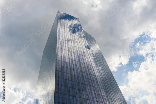 Office skycraper with cloudy sky on background. photo