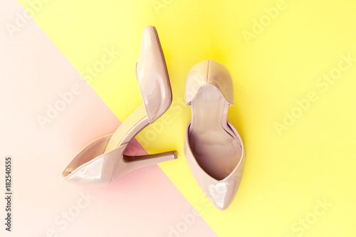 beautiful pink high heels on yellow and pink background