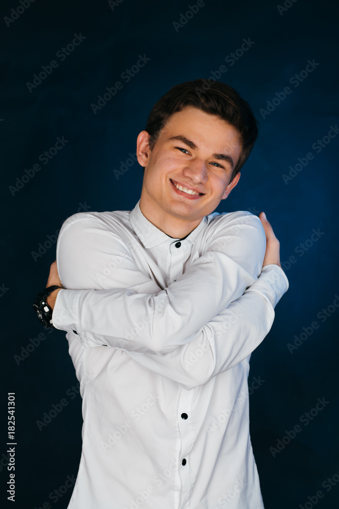 Fototapeta premium young brunette guy in a white shirt