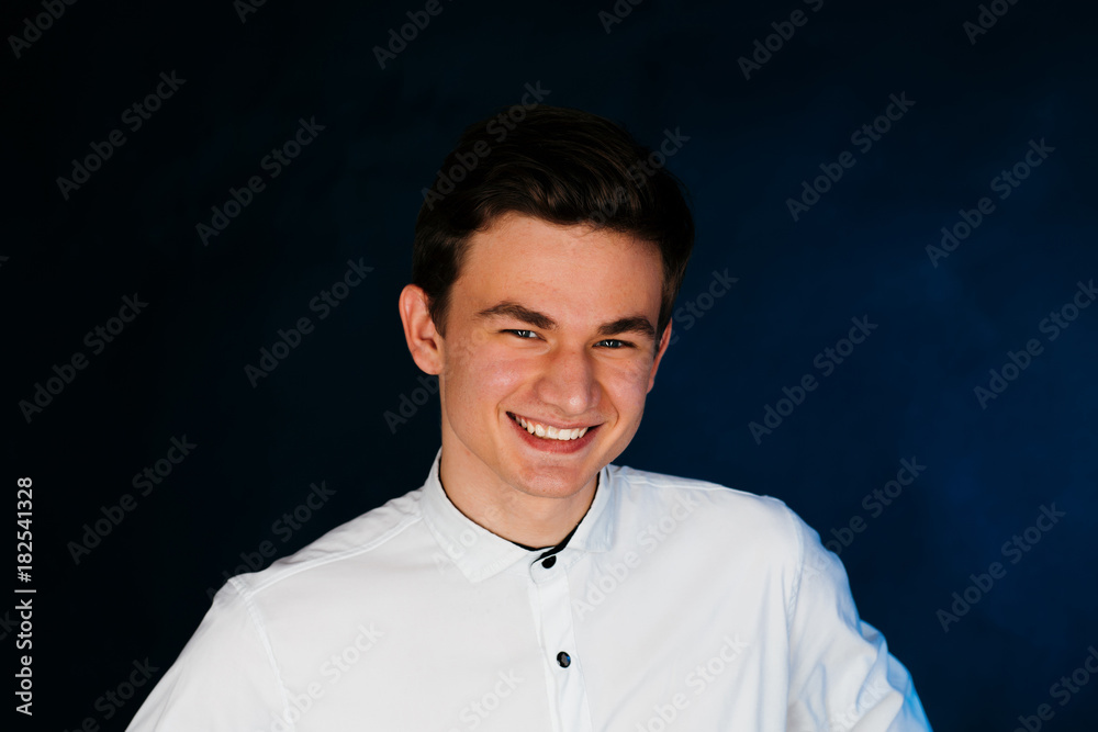 Fototapeta premium young brunette guy in a white shirt