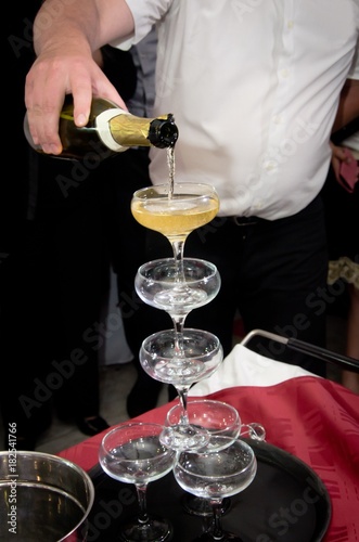 Champagne being poured for a toast to the bride and groom during a wedding or event