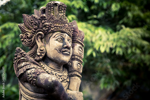 Stone carved balinese statue photo