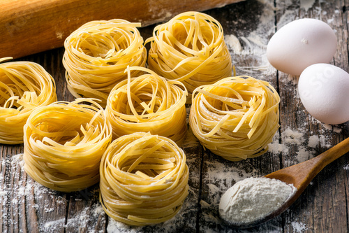 Homemade pasta on a wooden background