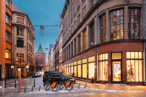 Riga, Latvia. Shop And Powder Tower On Valnu Street In Winter Evening photo