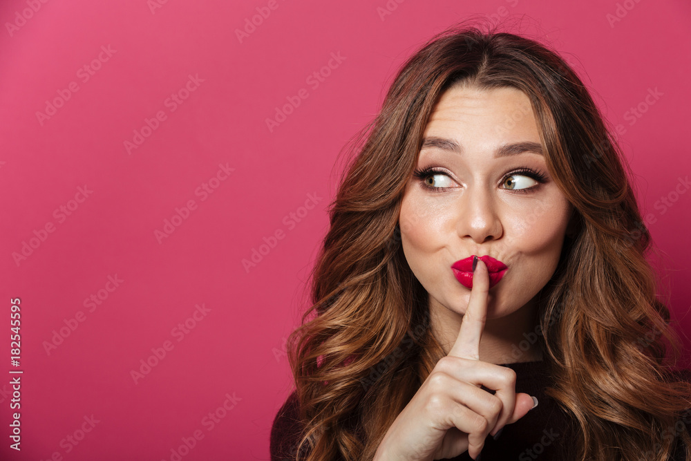 Pretty woman standing isolated over pink showing silence gesture. Pretty woman standing isolated over pink showing silence gesture.