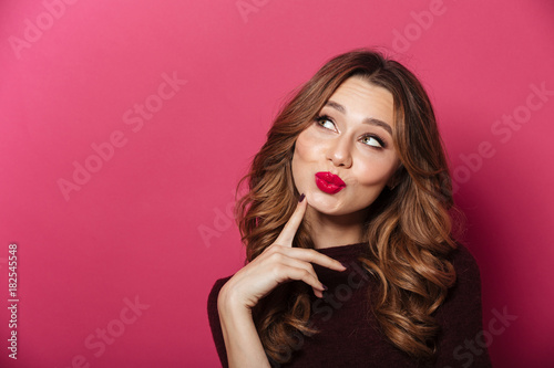 Beautiful woman standing isolated over pink background.