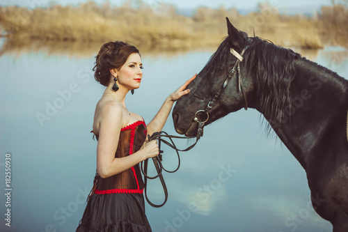 the woman next to the horse
