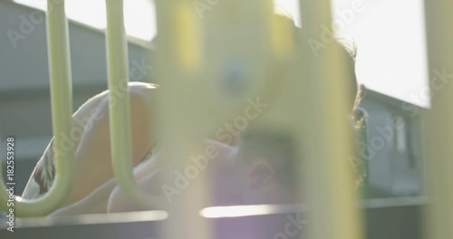 Mother helping toddler onto playstructure photo