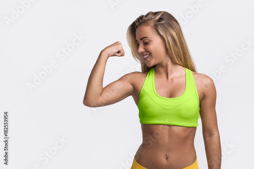 Strong sportswoman showing bicep