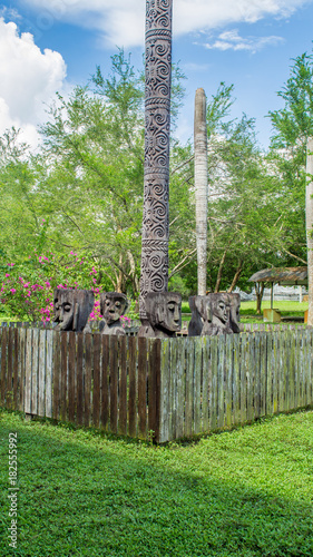 Configuration of traditional dayaknese (Indigenous tribe of Borneo / Kalimantan) wood sculptures / totem, in Pulau Kumala, Tenggarong, Indonesia photo