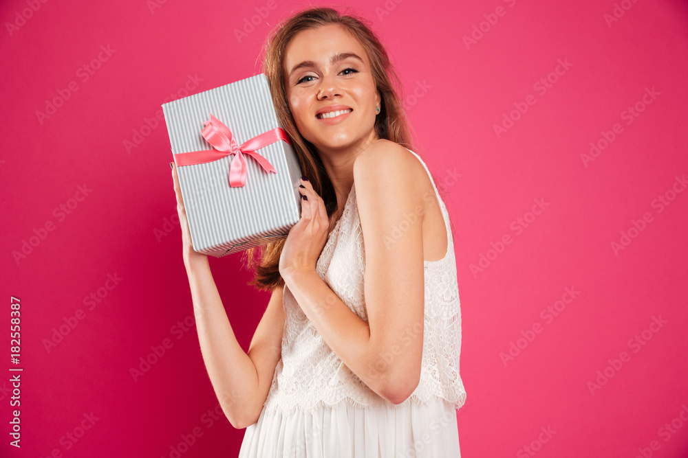 Portrait of a pretty smiling girl holding gift box Portrait of a pretty smiling girl holding gift box