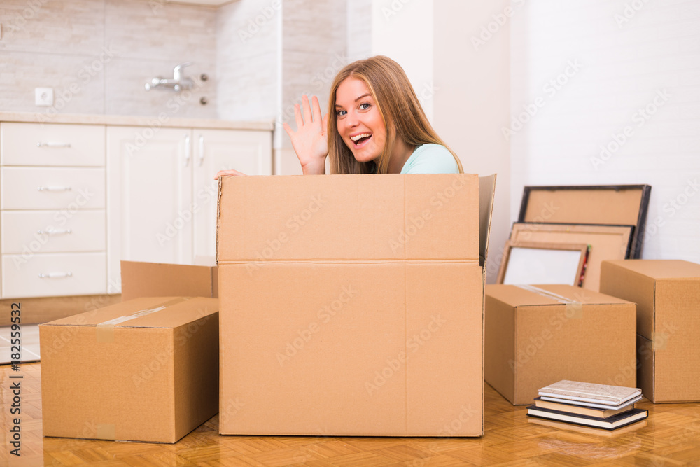 Happy woman having fun while moving into new home. Happy woman having fun while moving into new home.