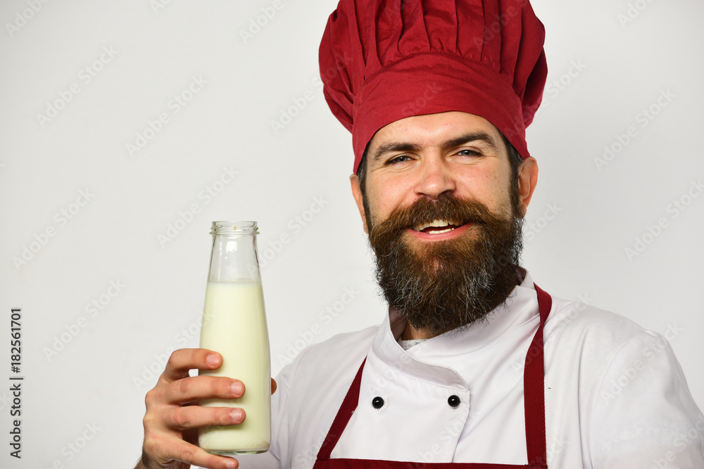 Organic ingredients concept. Cook with smiling face in burgundy uniform Organic ingredients concept. Cook with smiling face in burgundy uniform