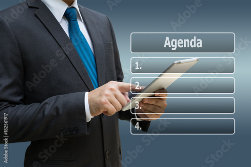 Businessman hand using digital tablet with virtual panel of agenda list
