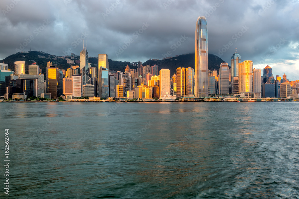 Naklejka premium Hong Kong City skyline at sunrise. View from across Victoria Harbor Hongkong.