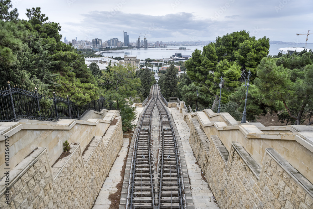 Azerbaijan, Baku: Section of tracks of Baku Funicular railway - top view with cityscape in the background. 
