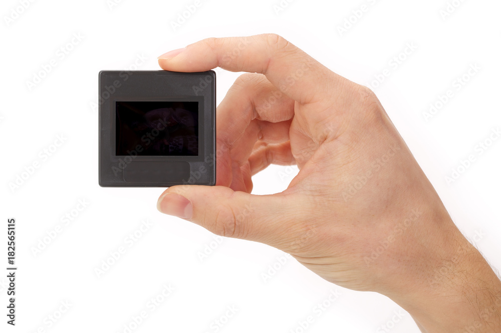 Hand holding plastic mounted slide on white background Hand holding plastic mounted slide on white background