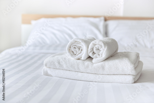 Freshly laundered fluffy towels on bed in hotel © bohbeh