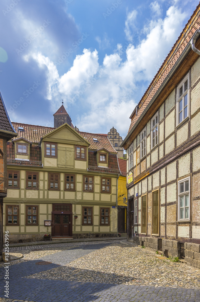 Naklejka premium QUEDLINBURG, GERMANY – August 16, 2017: View through narrow lanes at Finkenherd in the Old Town of Quedlinburg, Saxony-Anhalt, Germany.