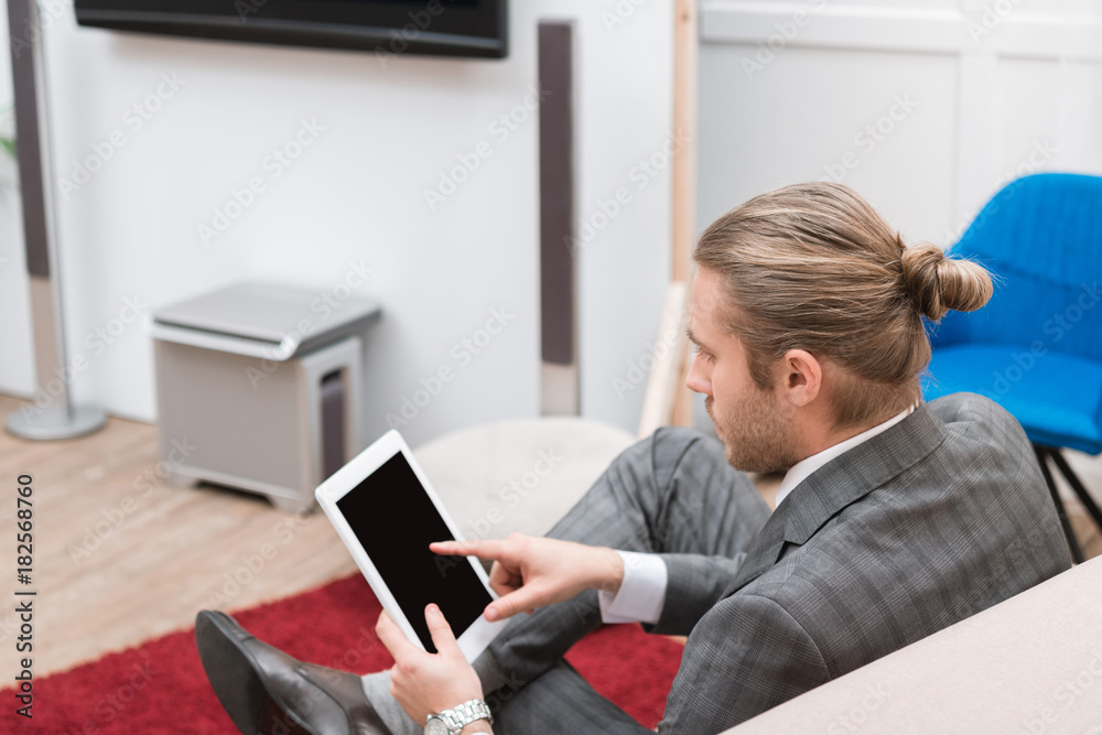 handsome businessman pointing at digital tablet at home handsome businessman pointing at digital tablet at home