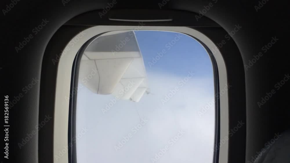 View from the passenger's Window Watching the Cloud High in the Sky on an Aeroplane View from the passenger's Window Watching the Cloud High in the Sky on an Aeroplane