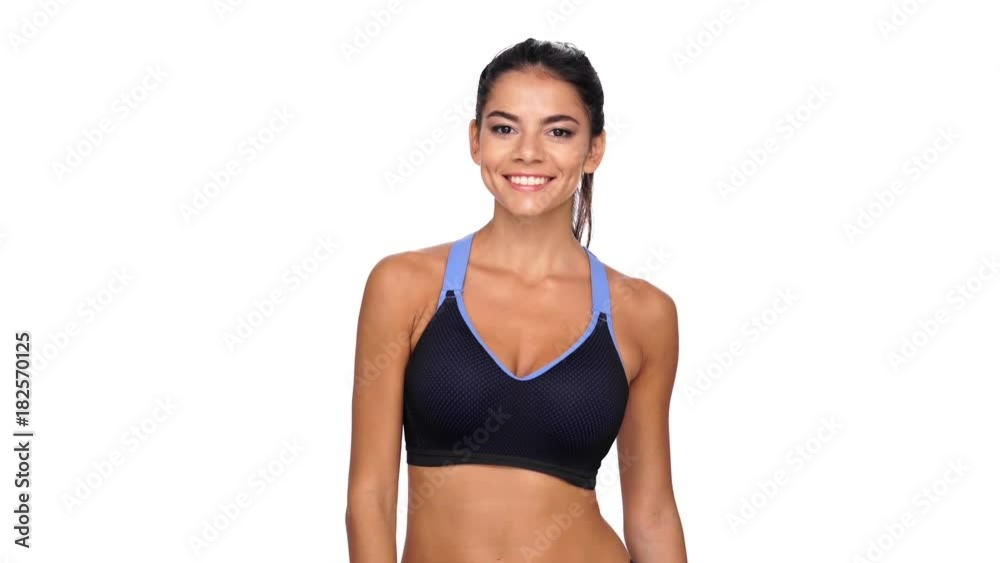 Happy brunette fitness woman showing ok sign and looking at camera over white background
Happy brunette fitness woman showing ok sign and looking at camera over white background