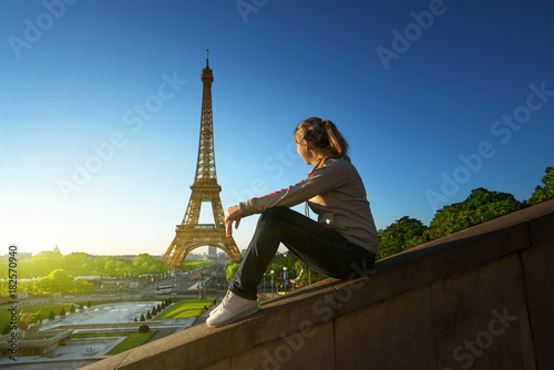 girl looking at the Eiffel tower in sunrise time, Paris © Iakov Kalinin