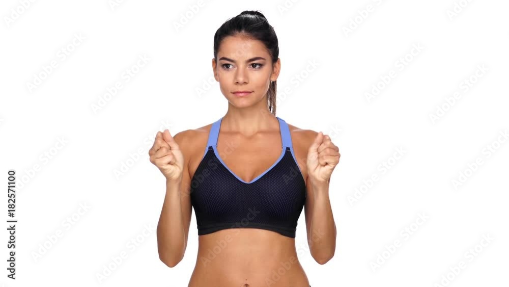 Concentrated brunette fitness woman warming up her hands over white background Concentrated brunette fitness woman warming up her hands over white background