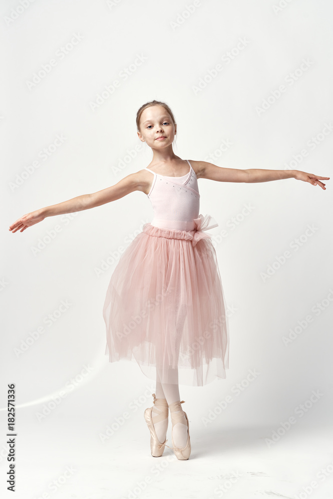 Naklejka premium little ballerina is dancing on a white background