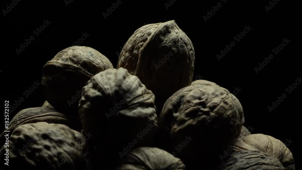 Walnuts on black background in rotation