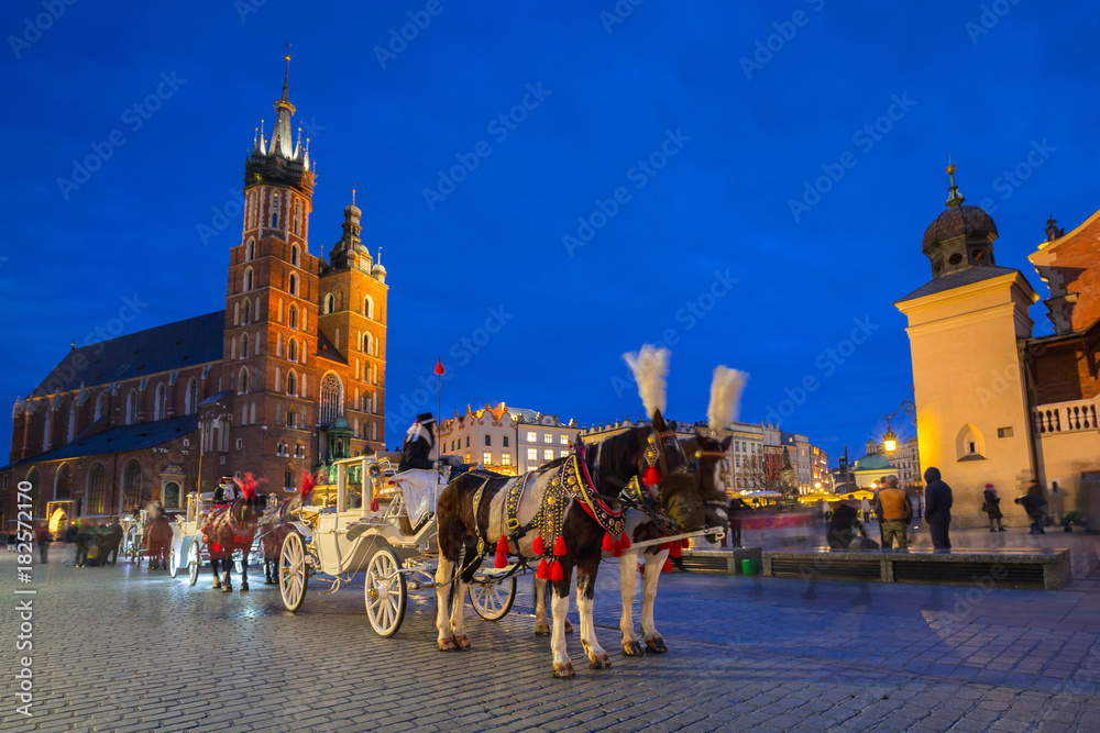 Naklejka premium Horse carriages at the Main Square in Krakow, Poland