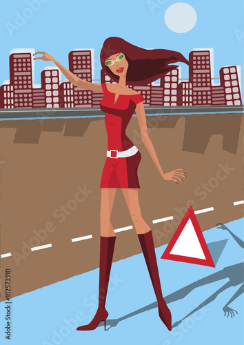 Beautiful girl in red dress catching on the road car with emergency sign nearby.