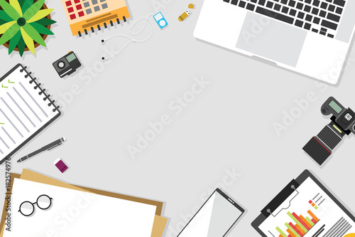 Top view of table working and working desk with gadget and free space for text with accessory on the table, laptop, notebook, desktop, phone, flash drive, coffee cup, letter, flowerpot, note, camera, 