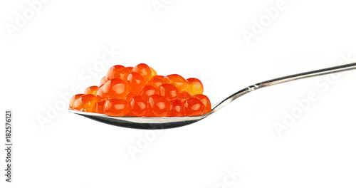 Metal spoon of red salmon caviar close up