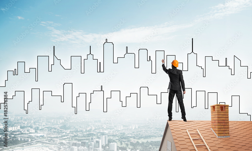 Man architect draw silhouette of modern city on blue sky. Mixed media
