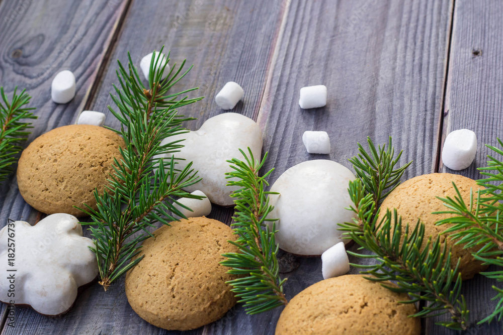 Christmas border with gingerbread, marshmallow and branch of fir tree Christmas border with gingerbread, marshmallow and branch of fir tree