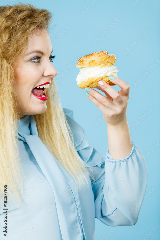 Funny woman holds cream puff cake Funny woman holds cream puff cake