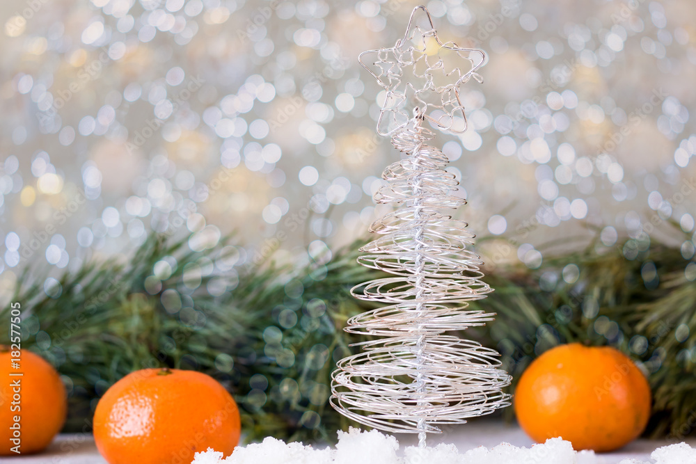 Christmas tree made of wire on a background of fir branches Christmas tree made of wire on a background of fir branches
