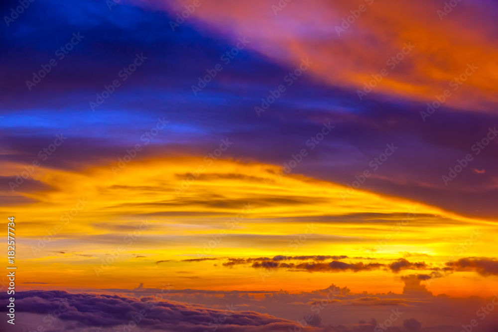 A colorful sunset in the clouds, a stunning natural phenomenon. Skyscape from the plane, at an altitude of 10,000 meters.