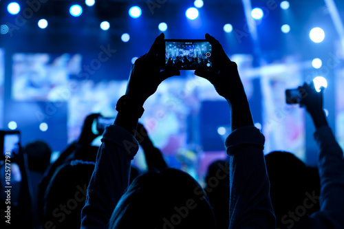 People at concert shooting video