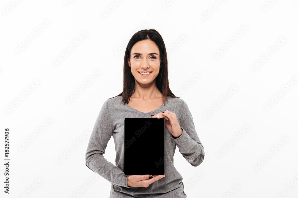 Young cheerful lady showing display of tablet computer. Young cheerful lady showing display of tablet computer.