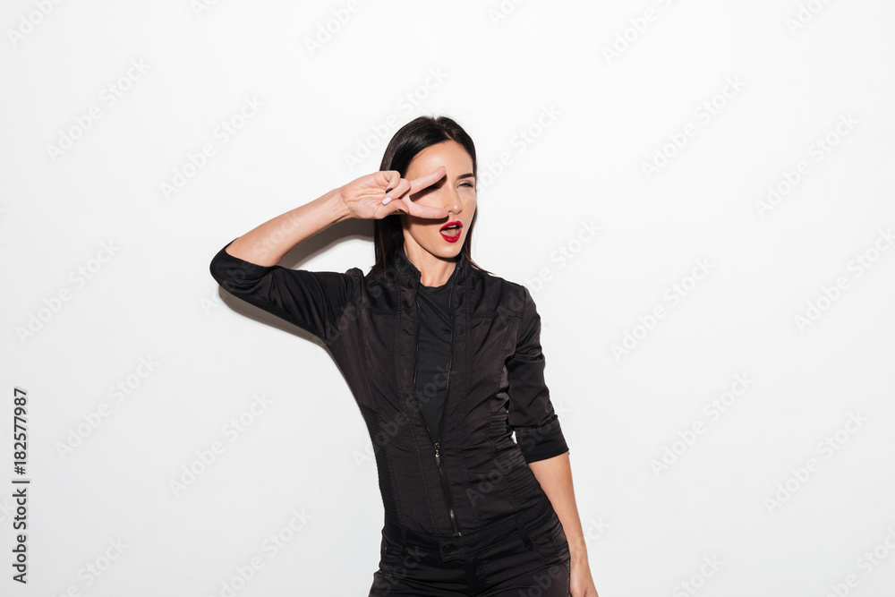 Beautiful woman with red lips showing peace gesture. Beautiful woman with red lips showing peace gesture.