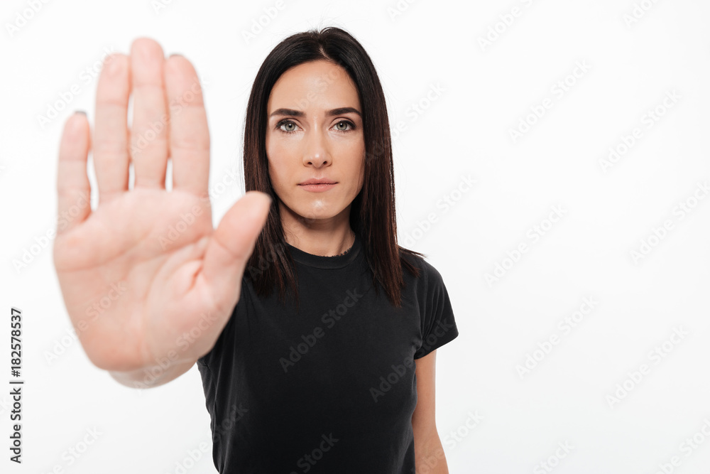 Portrait of a confident woman showing stop gesture Portrait of a confident woman showing stop gesture