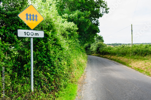 Fotografie Sign on a rural Irish road warning of an upcoming level crossing.