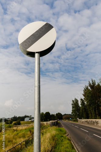 National Speed Limit sign on a country road photo