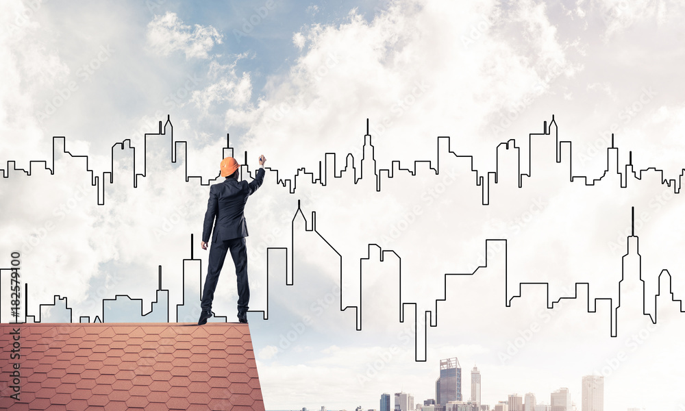 Man architect draw silhouette of modern city on blue sky. Mixed Man architect draw silhouette of modern city on blue sky. Mixed