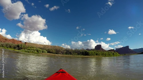 Family in kayaks and rafts on the colorado river near Moab Utah
