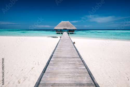 Wooden jetty leading to a terrace on water. Maldives